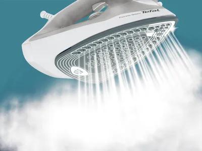 A close-up shot of a Tefal steam iron emitting a large amount of steam.
