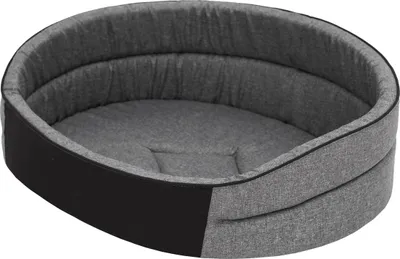 An oval-shaped dog bed with gray fabric and black accents.