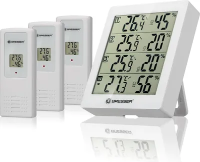A white digital thermo-hygrometer with three wireless sensors.