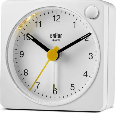 A white Braun alarm clock is shown against a white background.
