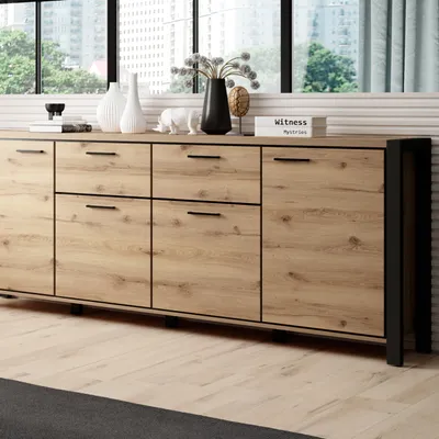 A sideboard with drawers and doors in a room with a window.