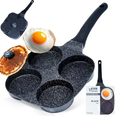 A frying pan with four circular compartments for cooking eggs or pancakes, shown with a cooked egg and a pancake with a blueberry on top. A smaller image of the pan and packaging is also visible.