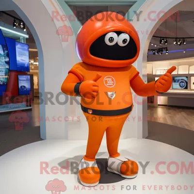 Produktbild von Orangefarbener REDBROKOLY American Football Helm Maskottchen Kostüm Charakter gekleidet in eine Yoga-Hose und Smartwatches