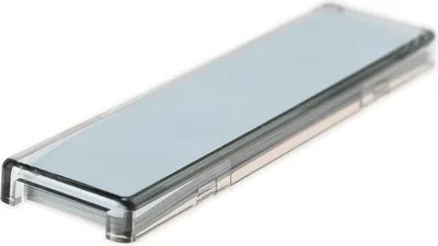 A close-up, angled view of a rectangular, clear plastic cover with a light gray insert, isolated on a white background.