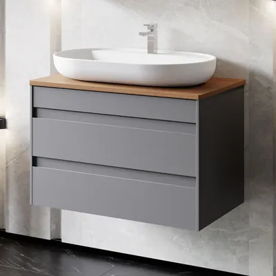 A modern bathroom vanity with a sink and faucet.