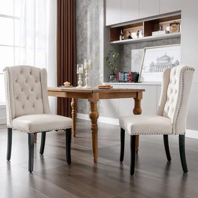 A dining room scene with two chairs and a table.