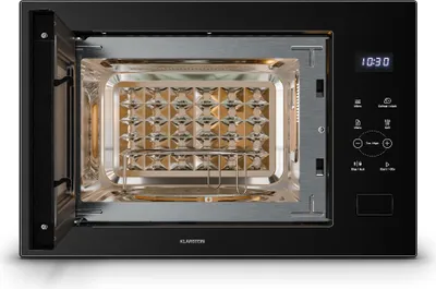 An open black microwave with its interior visible, showing a rack and a patterned surface.
