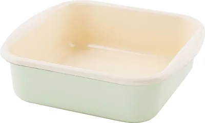 A square baking dish with a light green exterior and a cream-colored interior, shown from a slightly elevated side angle against a white background.
