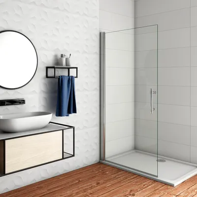 A modern bathroom with a sink, vanity, and shower enclosure.