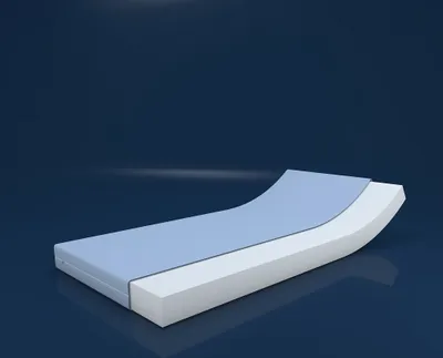 A white and light blue mattress displayed on a dark blue reflective surface with a dark blue background.