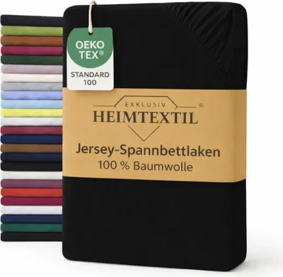A stack of folded bed sheets in various colors is shown on the left, with a black bed sheet in the foreground on the right, featuring a product label.