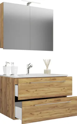 A bathroom vanity with a sink and a mirrored cabinet above it.