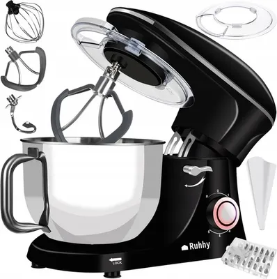 A black planetary kitchen mixer with various attachments is displayed against a white background. The mixer is shown with its lid open, revealing the mixing bowl and attachments. Several accessories are laid out around the mixer.