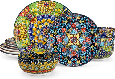 A set of colorful, patterned ceramic plates and bowls are arranged on a white background.