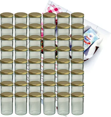 A collection of glass jars with golden lids, arranged in rows, with a small recipe booklet in the background.