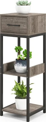 A three-tiered plant stand with a drawer, featuring plants on each shelf.