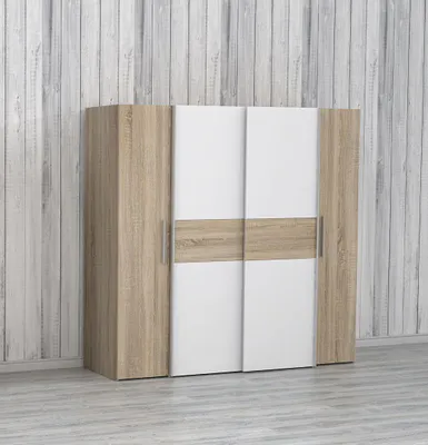 A modern wardrobe with sliding doors against a wood-paneled wall.