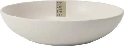 A close-up studio shot of a single, empty, cream-colored bowl.