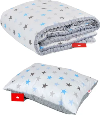 A folded blanket and a pillow, both with a star pattern, are displayed against a white background.