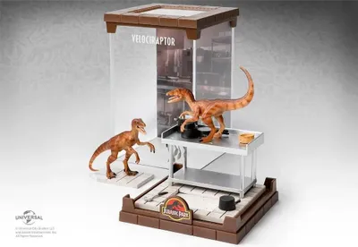 A display of two Velociraptor figures in a diorama setting, with a Jurassic Park logo.