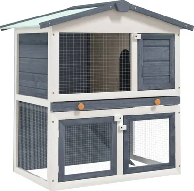 A two-story wooden rabbit hutch with multiple doors and wire mesh windows, presented against a white background.