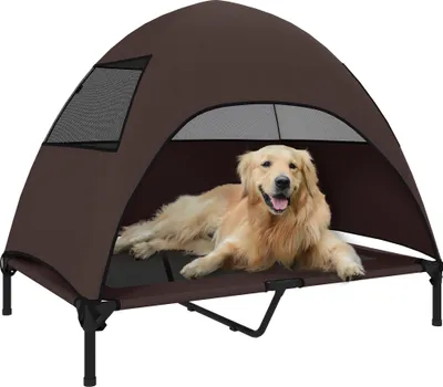 A golden retriever dog is lying on a raised pet bed with a brown canopy.