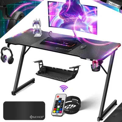 Produktbild von KESSER® Gaming Tisch LED | Z-Form Gamer Schreibtisch | Kopfhörerhaken & Kohlebeschichtung | Ergonomischer PC Computertisch | Stabiler Tisch mit Mauspad & Getränkehalter - 140cm x 60cm