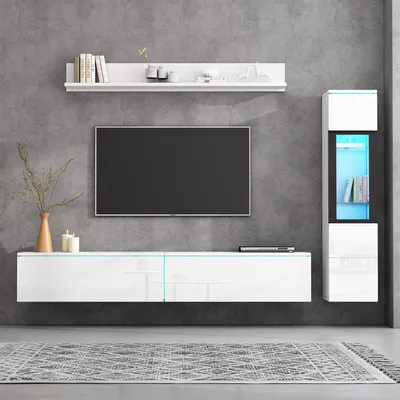 A modern living room setup with a wall-mounted TV, entertainment unit, and shelving.