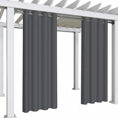 Two gray outdoor curtains hanging from a white pergola.