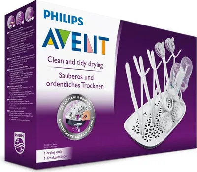 The image shows the retail packaging of a Philips AVENT bottle drying rack. The packaging is predominantly white and purple, with the product itself visible on the right side.