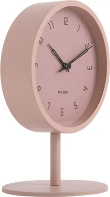 A pink Karlsson table clock on a white background.