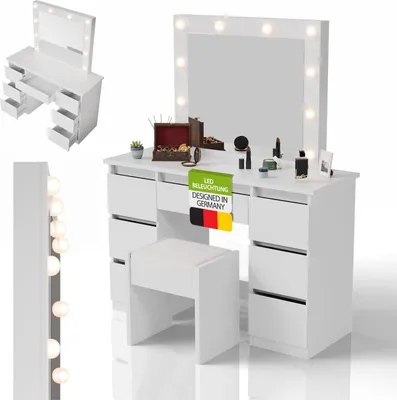 A white vanity table with a large mirror and stool, set against a white background. The table has multiple drawers and is adorned with makeup and decorative items.
