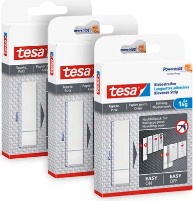 Three boxes of tesa Powerstrips adhesive strips are shown in a studio setting.