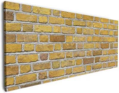 Produktbild von Wallario Premium Leinwandbild Ziegelsteinwand in gelb - Backsteine in Größe 50 x 125 cm