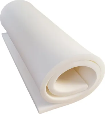 A rolled-up piece of white foam material, likely a mattress topper or foam sheet, is shown against a white background.