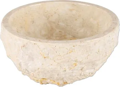 A close-up, slightly angled view of a beige marble basin.