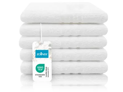 A stack of white towels with a tag.