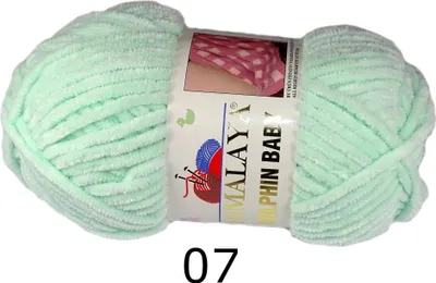 A ball of light green yarn on a white background.