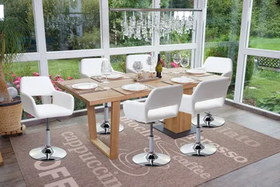 A dining set with chairs and table in a sunroom or conservatory.