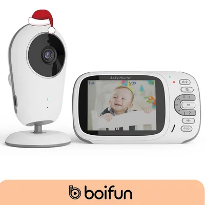 A baby monitor set, including a camera and a parent unit, with a baby smiling on the screen.