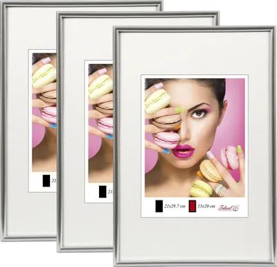 A set of three silver photo frames, with the rightmost frame displaying a close-up of a woman holding macarons.