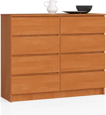 A wooden dresser with eight drawers is shown against a white background. Decorative items are placed on top.