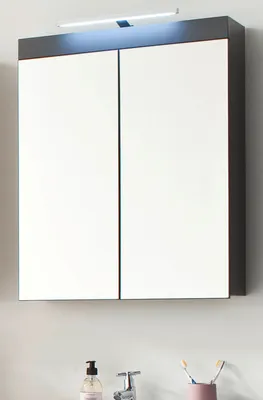 A medicine cabinet with mirrored doors mounted on a wall above a sink.