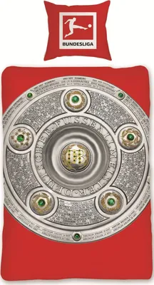 A Bundesliga Meisterschale trophy on a red background, with a pillow featuring the Bundesliga logo above it.