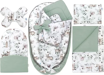 A flat lay of a baby nest set with various accessories, all featuring a woodland animal and foliage print.