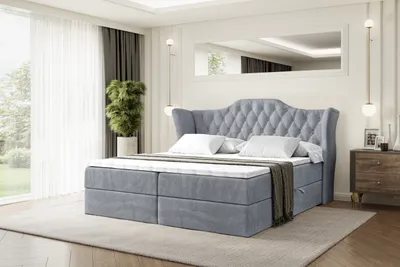 A bedroom with a large bed as the main focus.