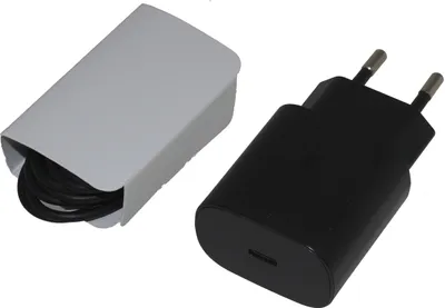 A black USB-C charger and a white cable organizer are shown against a white background.