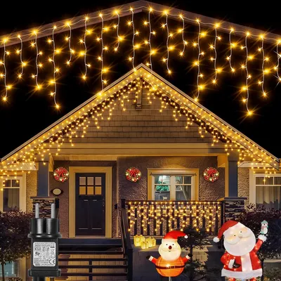 A house decorated with Christmas lights and figures for the holidays.
