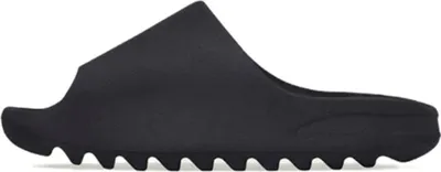 A black Yeezy slide is shown from the side against a white background.