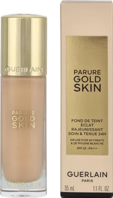A bottle of Guerlain Parure Gold Skin foundation and its packaging are shown against a white background.